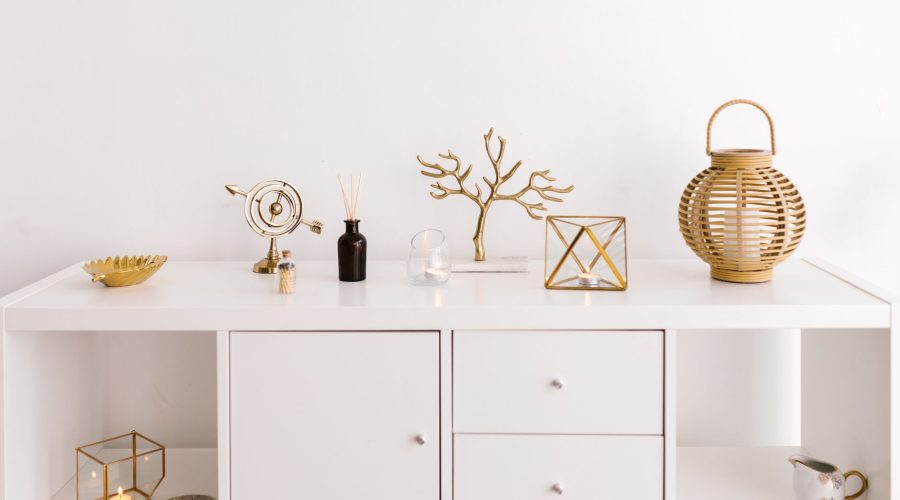 Sleek white cabinet with elegant gold decorations on a modern white background — Durable Door Architrave Ideal for Long-Term