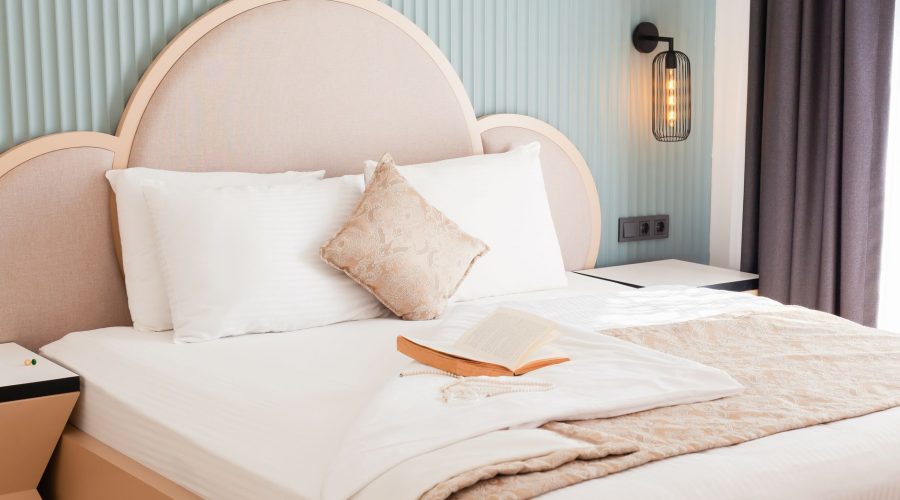 A luxurious hotel bedroom featuring elegant bedding and an open book, exuding comfort and style. — Eco-Accreditation Of Yarra