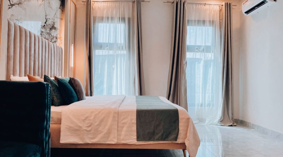 Chic hotel room interior design featuring a stylish bed, curtains, and natural light. — Finding Luxury Dog Friendly Accommoda