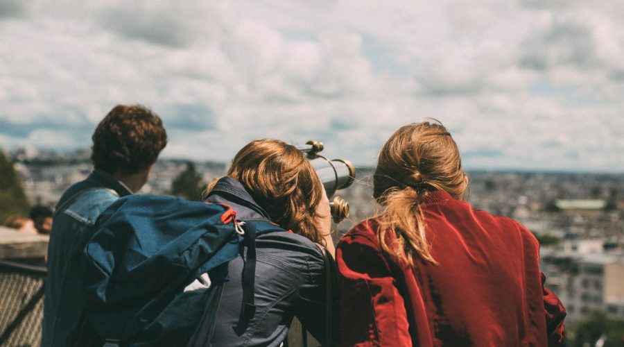 A group of young tourists exploring Paris views through a telescope during the day. — Lake fishing - the best and perfect pla
