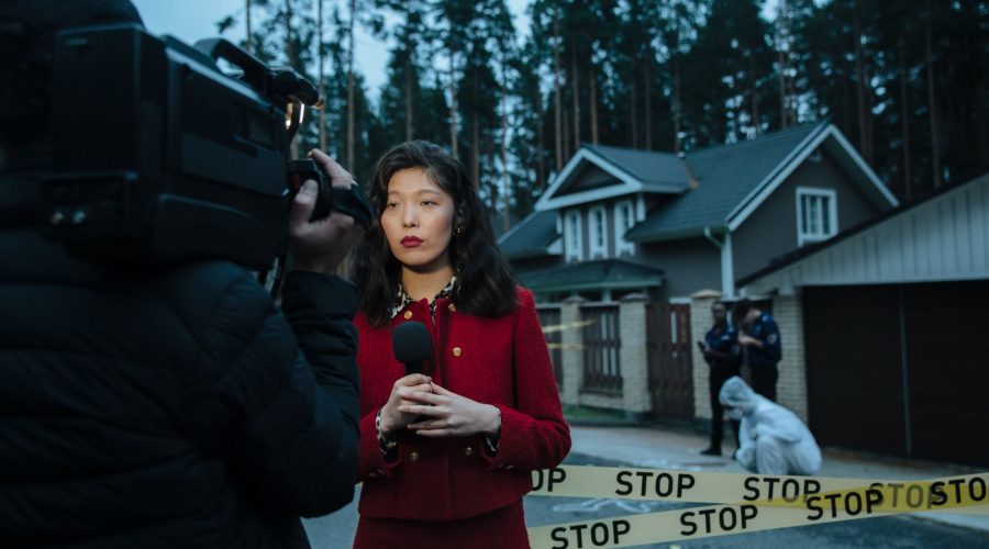 Female journalist reporting live from a crime scene with police and cameraman. — The Watchman Device: A New Hope for Heart Pa