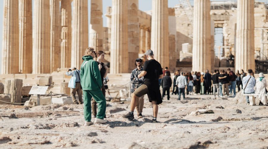 A group of tourists exploring the ancient ruins of the Parthenon in Athens, Greece. — Travel with Pets