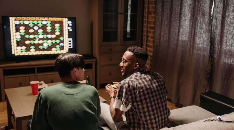 Two friends playing video games together in a cozy living room setting. — What Are Battlefield 2042 In Association With Battl